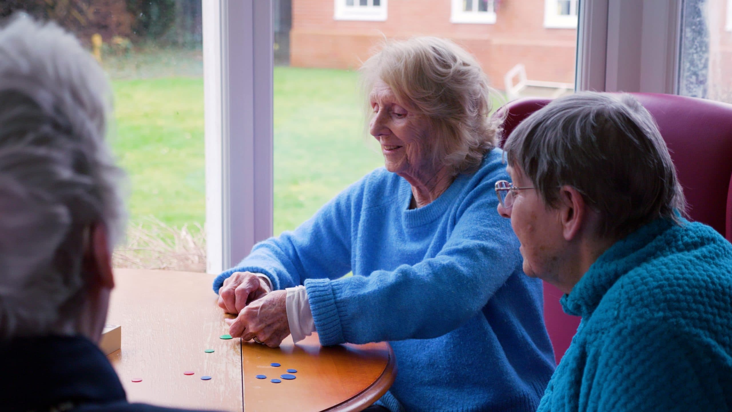 Residents playing a table game together